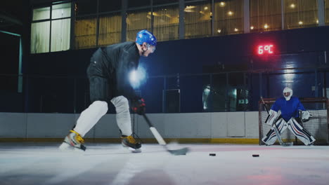 Professional-hockey-player-and-goalkeeper-train-punching-puck-on-goal.-Goalkeeper-and-player-in-training.-Slow-motion